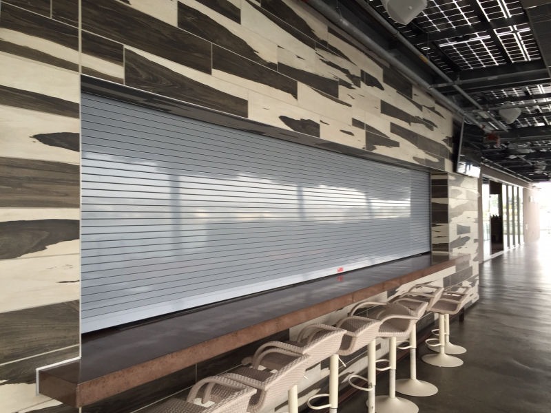 The Insulated Counter Rolling Door provides the additional benefits of thermal and air filtration control to all the benefits the Heavy Duty Counter Door provides. It is the appropriate counter door for openings with heavy daily operations that needs high resistant against vandalism plus the insulated factor; this door is also capable to withstand Hurricane Pressures and can be ordered for manual or motor operation.